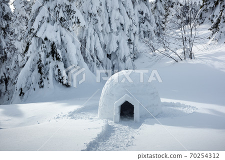 Real snow igloo house in the winter Carpathian mountains 70254312