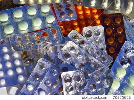 Many colorful tablets and medicines drugs in plastic pharmaceutical packaging Many colorful tablets and medicines drugs in plastic pharmaceutical packaging 70255696