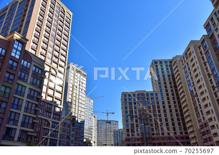Facade of a new modern high-rise residential building. Skyscraper on blue sky background 70255697