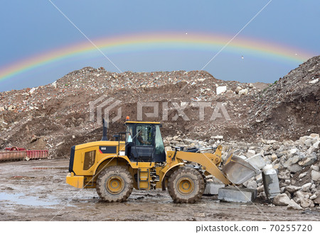 Wheel loader at landfill for disposal of construction waste. Wheel loader at landfill for disposal of construction waste. 70255720