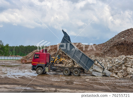 Dump truck unloading old concrete and asphalt from demolition for recycling Dump truck unloading old concrete and asphalt from demolition for recycling 70255721
