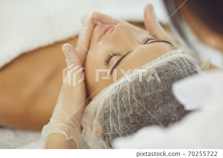 Woman face skin massage treatment in cosmetic spa beauty salon 70255722