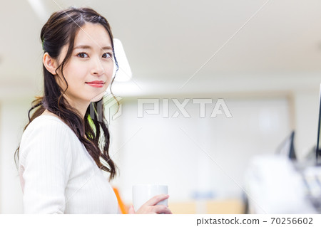 Female employees holding remote meetings in the office Female employees holding remote meetings in the office 70256602