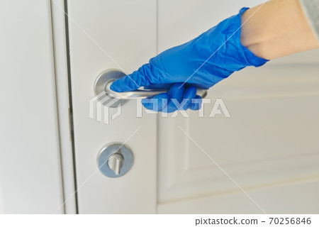 Close-up of hand in rubber glove opening door Close-up of hand in rubber glove opening door 70256846
