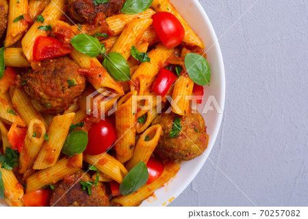 Italian penne pasta with meatballs and tomatoes 70257082