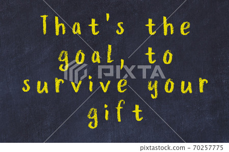 Chalk inscription of smart quote on black desk 70257775