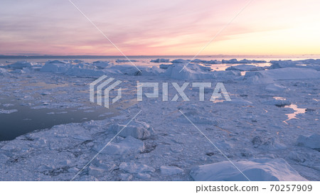 Iceberg from glacier in arctic nature landscape on Greenland. Aerial photo drone footage of icebergs in Ilulissat icefjord. Affected by climate change and global warming Iceberg from glacier in arctic nature landscape on Greenland. Aerial photo drone footage of icebergs in Ilulissat icefjord. Affected by climate change and global warming 70257909
