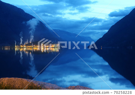 Night city Odda in the reflection of water. Norway 70258228