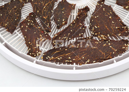 dried beef slices in spices with sesame seeds dried beef slices in spices with sesame seeds 70259224