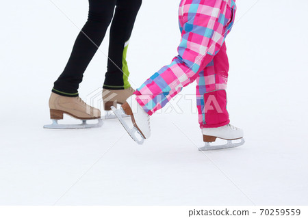 foot skating little girls and women on an ice rink foot skating little girls and women on an ice rink 70259559