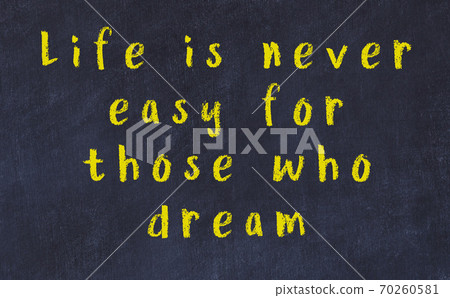 Chalk inscription of smart quote on black desk Chalk inscription of smart quote on black desk 70260581