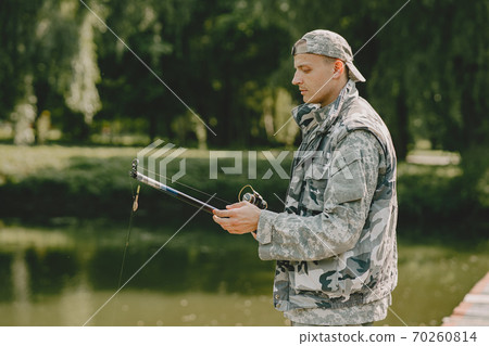 Man fishing and holds the angling rod Man fishing and holds the angling rod 70260814