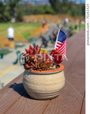 Patriotic flower pot with American flags and golfer on the background. 70261425
