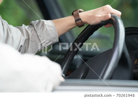 Hands of a man driving Hands of a man driving 70261948