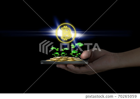 Human hand holding mobile smart phone with piles of golden coins and bitcoin symbol,Lucky economic growth concept Human hand holding mobile smart phone with piles of golden coins and bitcoin symbol,Lucky economic growth concept 70265059