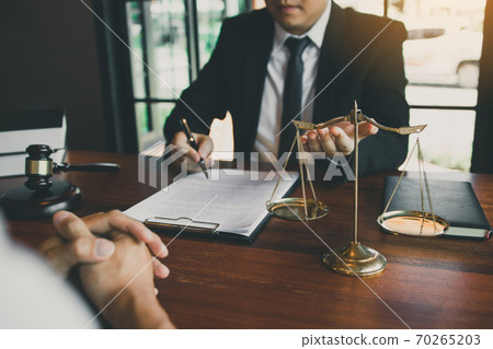 Lawyer is explaining about the wrongdoing laws regarding fraud to the client at the office. 70265203