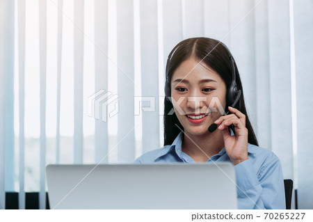 Close up call center worker was smiling at his office. 70265227