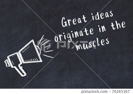 Chalk loudspeaker and wise quote on black desk 70265367