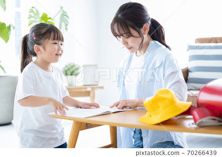 Family image Girl doing homework with mom 70266439