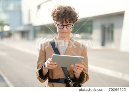 Young pretty brunette businesswoman with tablet watching business webinar Young pretty brunette businesswoman with tablet watching business webinar 70266525