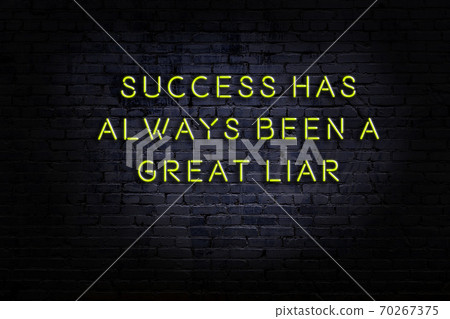Wise quote. Neon inscription against brick wall Wise quote. Neon inscription against brick wall 70267375