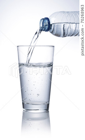 Pour water from a plastic bottle into a glass Pour water from a plastic bottle into a glass 70268963
