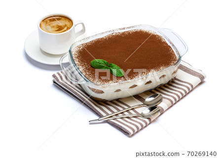 Traditional Italian Tiramisu dessert in glass baking dish and cup of fresh espresso coffee isolated on white background with clipping path 70269140