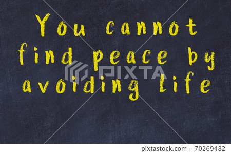 Chalk inscription of smart quote on black desk 70269482