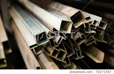 Metal profile of the pipe lies on the shelves in the workshop Metal profile of the pipe lies on the shelves in the workshop 70271367