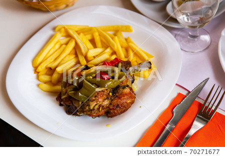 Delicious baked with vegetables pork with french fries Delicious baked with vegetables pork with french fries 70271677