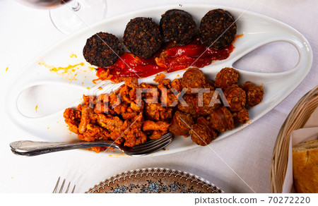 Spanish snack of blood sausage with chorizo, picadillo and roasted pepper Spanish snack of blood sausage with chorizo, picadillo and roasted pepper 70272220