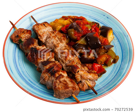 Grilled pork meat shashlik with sauteed vegetables 70272539