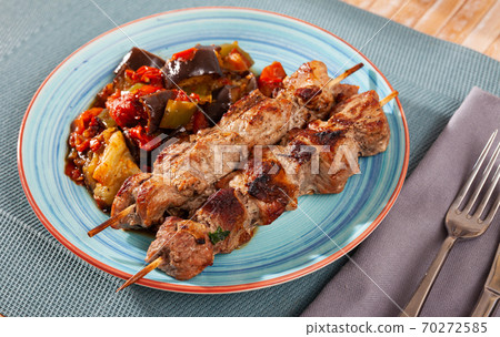 Grilled pork meat shashlik with sauteed vegetables 70272585