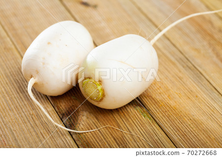 Whole white radishes on wooden surface Whole white radishes on wooden surface 70272668