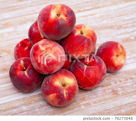 Whole and half fresh red peaches on wooden table. Whole and half fresh red peaches on wooden table. 70273048
