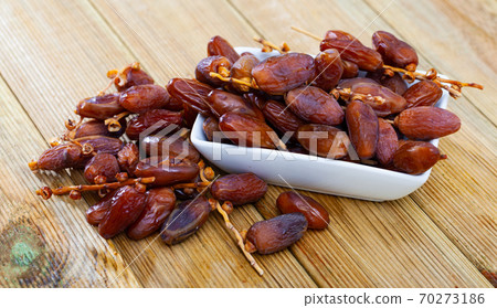 Fresh dates on wooden background, healthy snack Fresh dates on wooden background, healthy snack 70273186