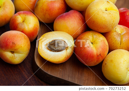 Apricots fruit on wooden table. Vitamin fruits 70273252
