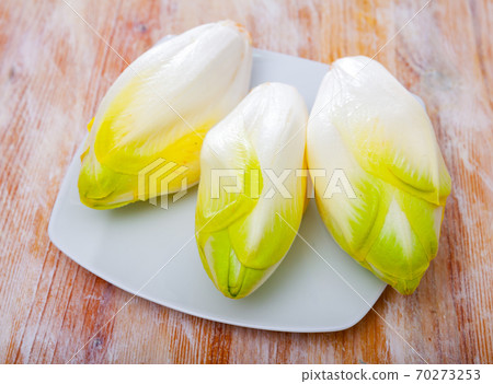 Image of fresh raw endive on the wooden table 70273253