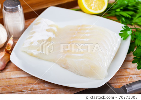 Raw seafood, fresh eel fillet on wooden board 70273305
