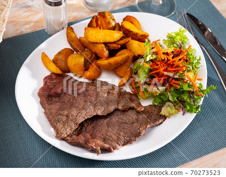 Grilled lamb with baked potato, homemade dinner 70273523