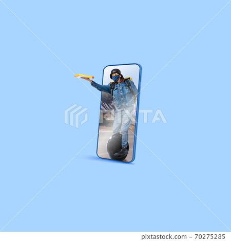 Handsome delivery man giving order right from smartphone's screen, fast delivery concept Handsome delivery man giving order right from smartphone's screen, fast delivery concept 70275285