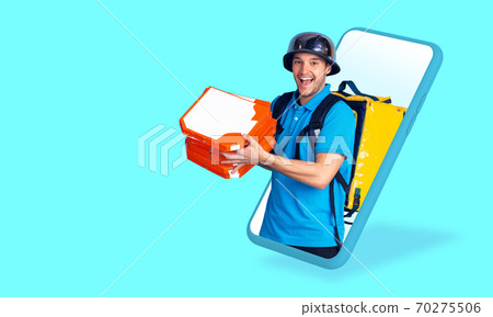 Handsome delivery man giving order right from smartphone's screen, fast delivery concept Handsome delivery man giving order right from smartphone's screen, fast delivery concept 70275506