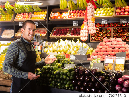 seller offering fresh vegetables and fruits 70275840