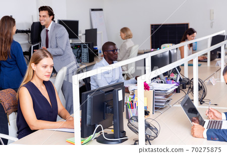 Multiracial group of successful business people during daily work in modern co-working space Multiracial group of successful business people during daily work in modern co-working space 70275875
