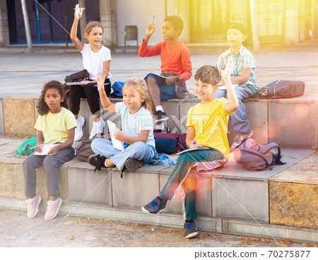 Group of kids having open air lesson Group of kids having open air lesson 70275877