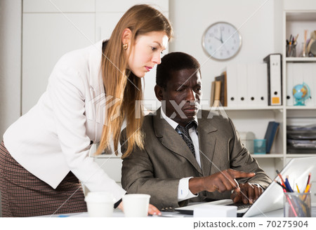 Focused coworkers working together 70275904
