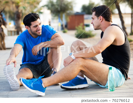 Friends resting after training Friends resting after training 70276012