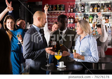 Colleagues discussing at corporate party Colleagues discussing at corporate party 70276178