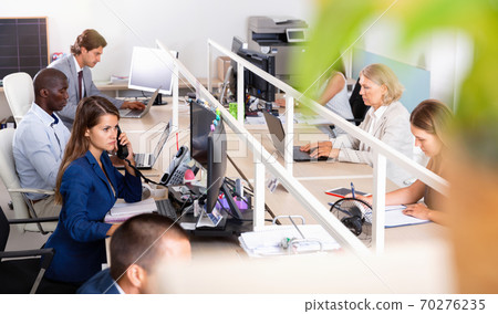 Multiracial group of successful business people during daily work in modern co-working space 70276235