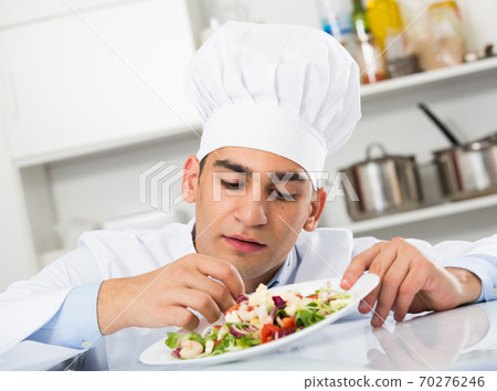 Male is degustating salad Male is degustating salad 70276246